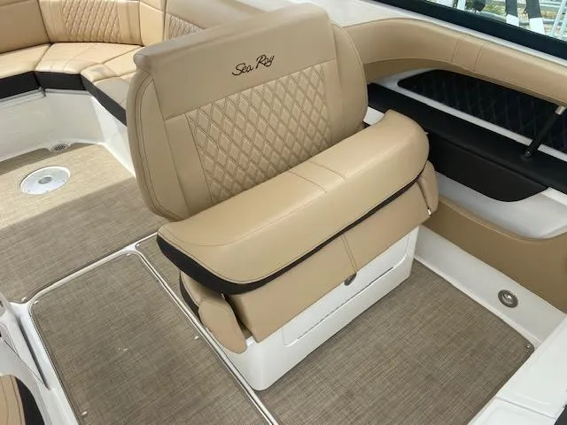 Slide: The Image of 2021 Sea Ray 310 SLX boat interior with tan leather seating and diamond stitching. - 14
