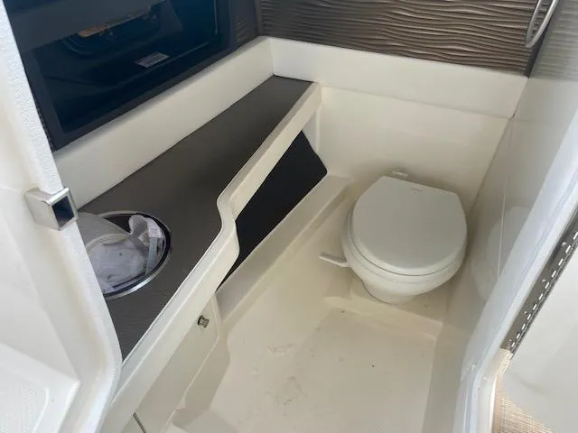 Slide: The Image of 2021 Sea Ray 310 SLX boat bathroom with toilet and sink. - 15