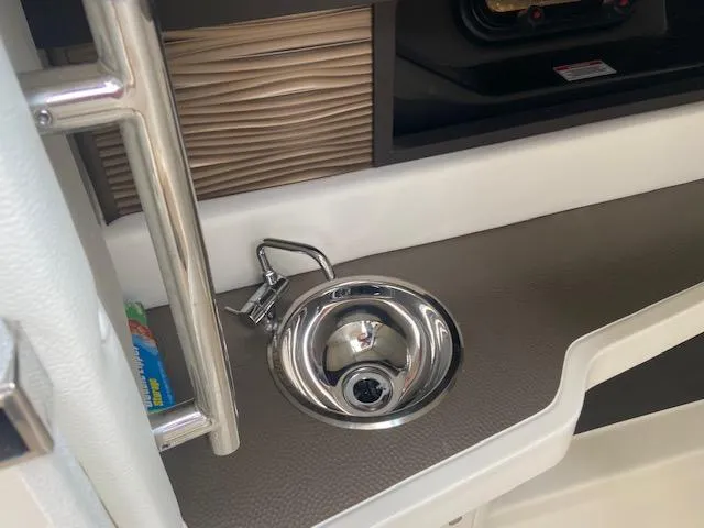 Slide: The Image of 2021 Sea Ray 310 SLX boat interior sink and countertop. - 16