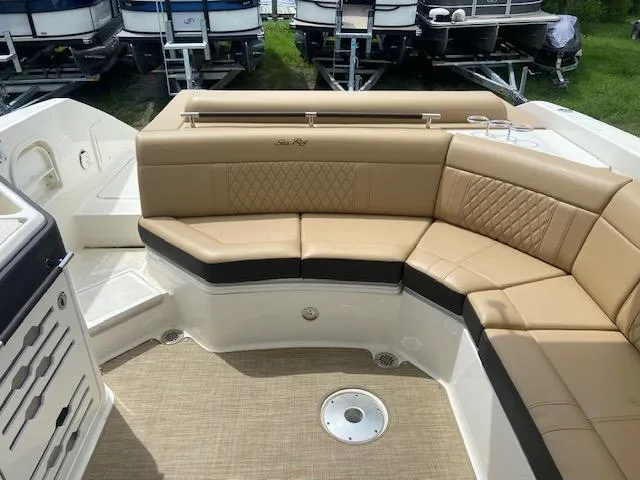 Slide: The Image of 2021 Sea Ray 310 SLX boat with tan leather seating in the cockpit area. - 19