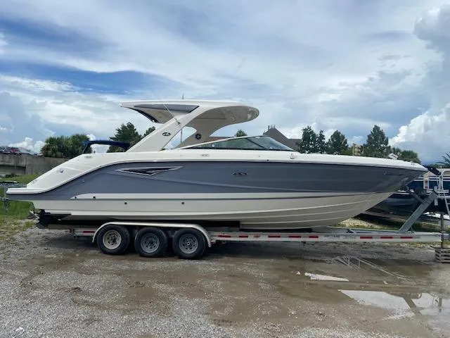 Slide: The Image of 2021 Sea Ray 310 SLX boat on a trailer, side view. - 2