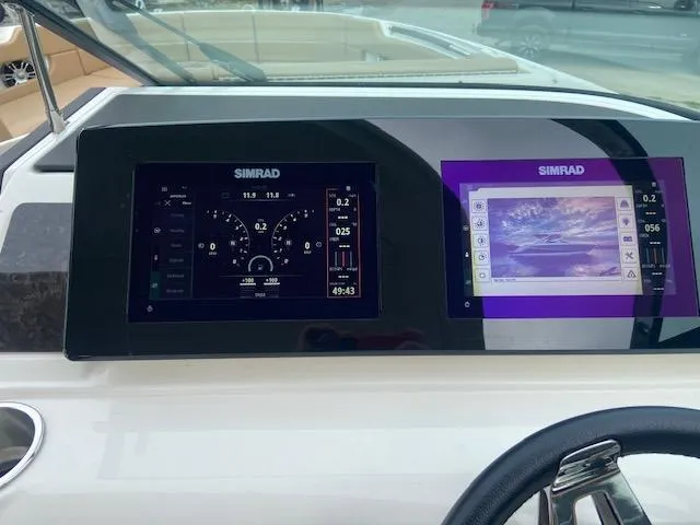 Slide: The Image of Dashboard of a 2021 Sea Ray 310 SLX with Simrad displays. - 21