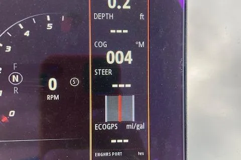 Slide: The Image of Close-up of 2021 Sea Ray 310 SLX boat dashboard display showing depth, COG, and RPM. - 23
