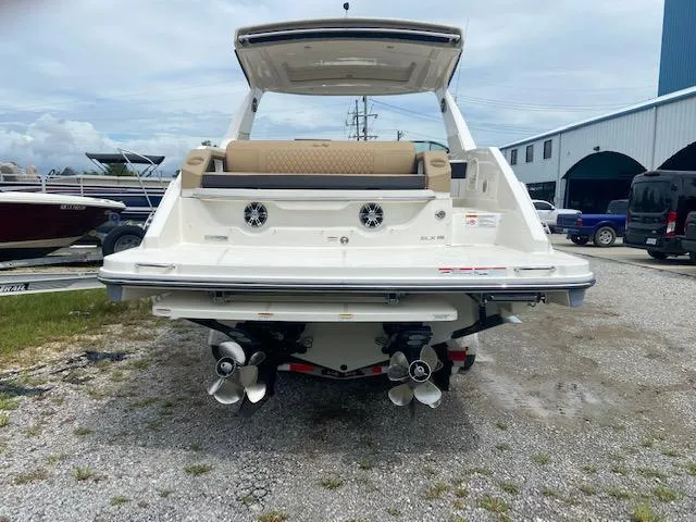 Slide: The Image of 2021 Sea Ray 310 SLX boat rear view at a marina. - 5