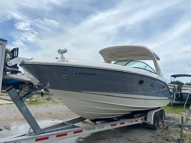 Slide: The Image of 2021 Sea Ray 310 SLX boat on a trailer under a cloudy sky. - 8