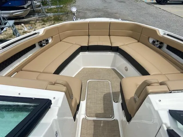 Slide: The Image of 2021 Sea Ray 310 SLX boat with spacious tan seating and modern design. - 9