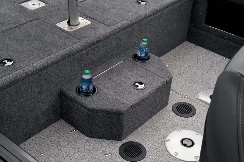 Slide: The Image of 2023 Tracker Targa V-19 WT boat interior with cup holders and carpeted flooring. - 26