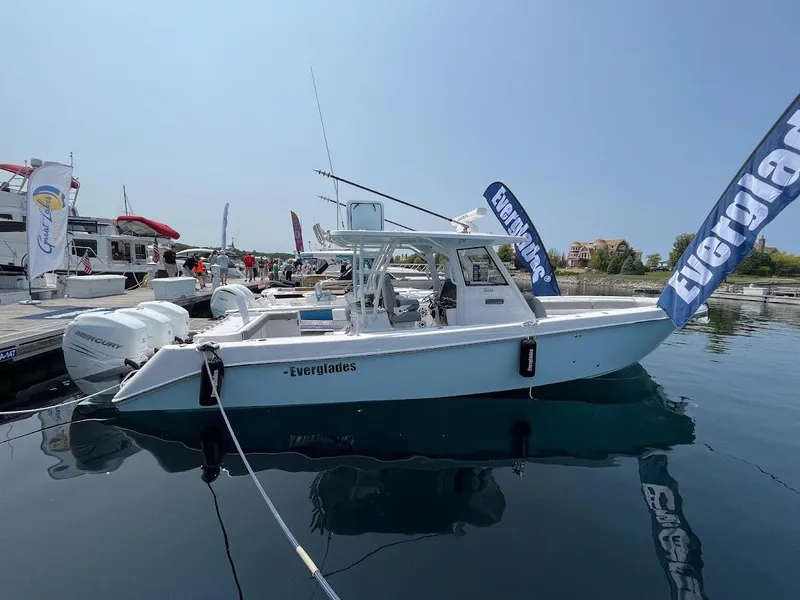Slide: The Image of 2023 Everglades 365 CC boat docked at marina with clear blue sky. - 1