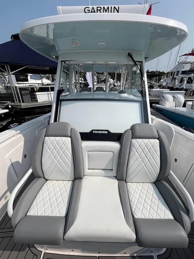 Slide: The Image of 2023 Everglades 365 CC boat with Garmin electronics, featuring luxurious seating at the helm. - 10