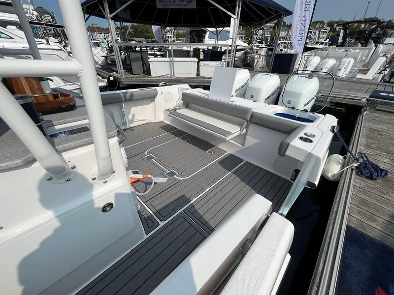 Slide: The Image of 2023 Everglades 365 CC boat interior at marina, featuring spacious deck and seating. - 3
