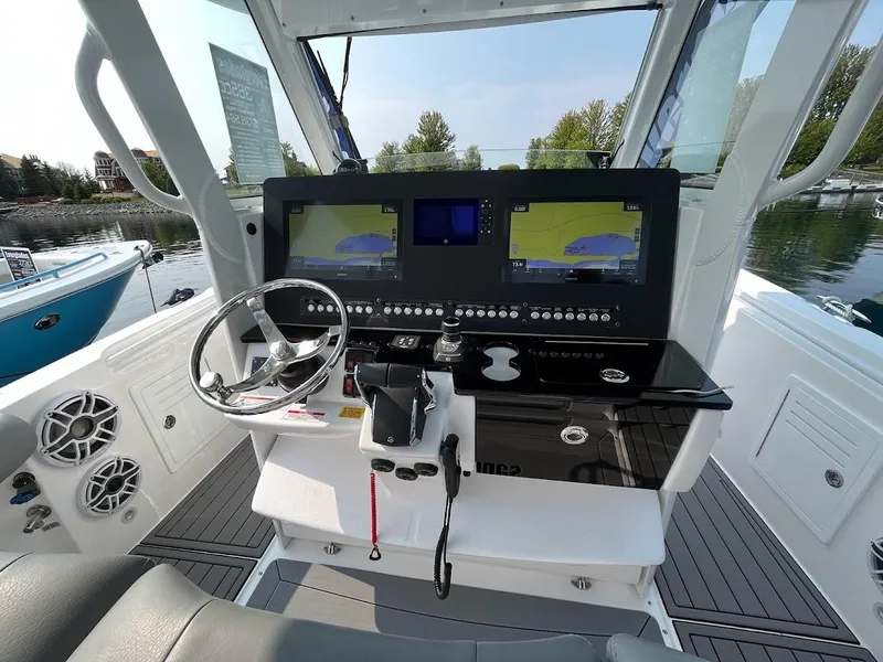 Slide: The Image of 2023 Everglades 365 CC boat helm with dual navigation screens and modern controls. - 6