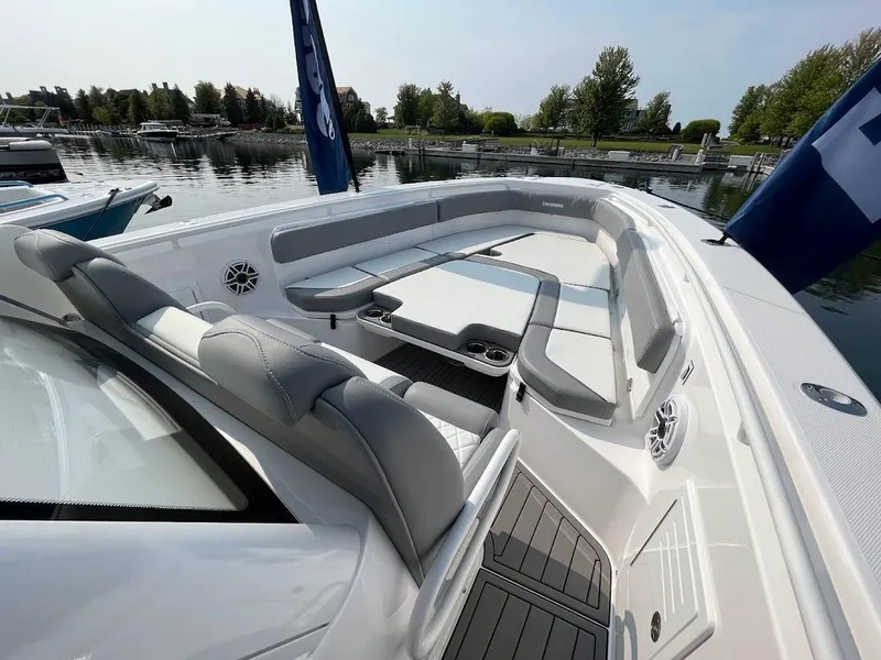 Slide: The Image of 2023 Everglades 365 CC boat with spacious seating and modern design at a marina. - 8