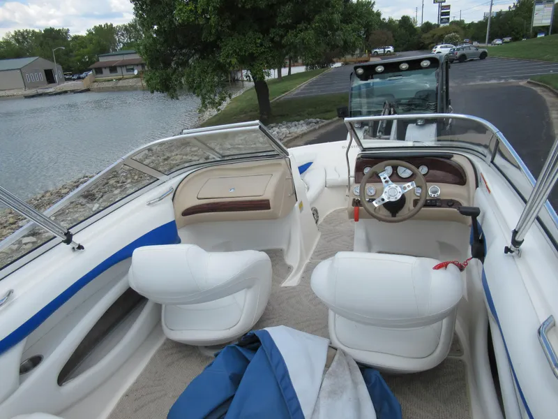 Slide: The Image of 2008 Glastron GXL 185 boat interior with white seats and steering wheel. - 10