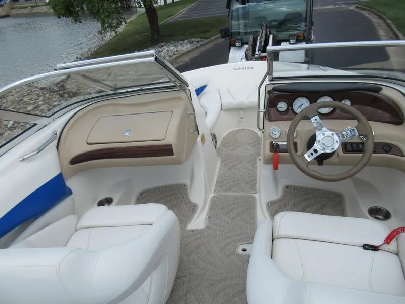 Slide: The Image of 2008 Glastron GXL 185 boat interior with steering wheel and seating. - 11