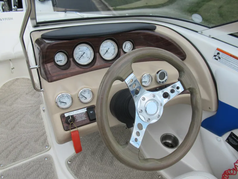 Slide: The Image of 2008 Glastron GXL 185 boat dashboard with steering wheel and gauges. - 13