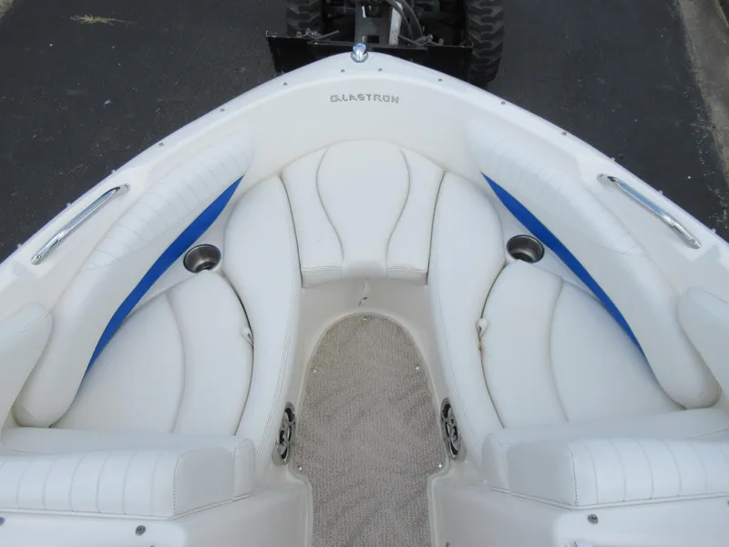 Slide: The Image of 2008 Glastron GXL 185 boat interior with white and blue seating. - 16