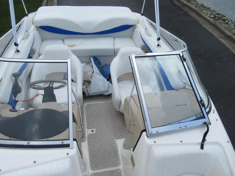 Slide: The Image of 2008 Glastron GXL 185 boat interior with white and blue seating. - 18