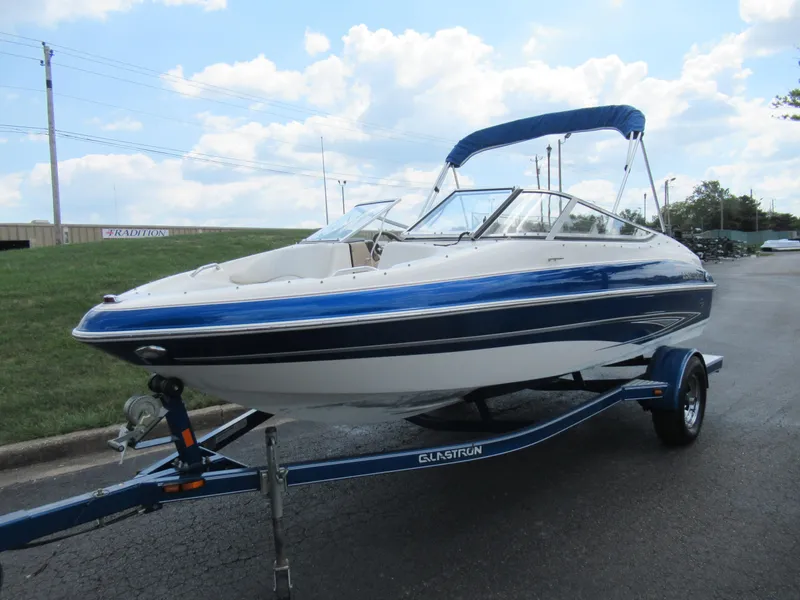 Slide: The Image of 2008 Glastron GXL 185 boat with blue and white exterior on a trailer. - 5