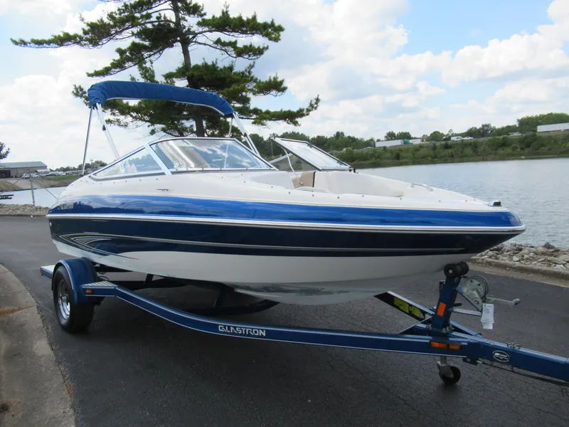 Slide: The Image of 2008 Glastron GXL 185 boat on trailer by a lake. - 8