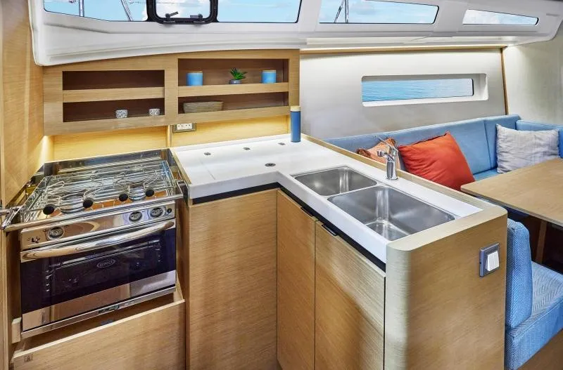 Slide: The Image of Modern kitchen interior of 2024 Jeanneau Sun Odyssey 380 yacht, featuring sleek design and amenities. - 8