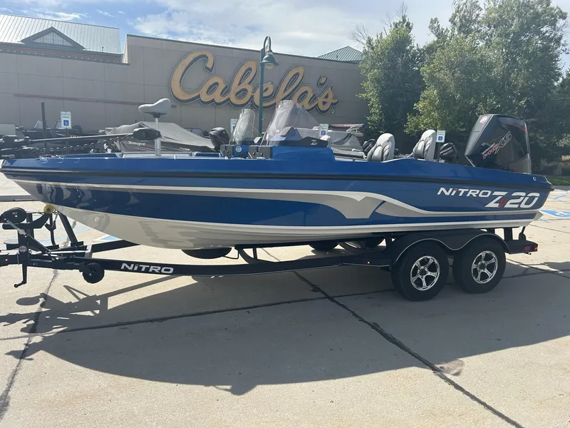 Slide: The Image of 2023 Nitro ZV20 boat on trailer outside Cabela's store. - 4