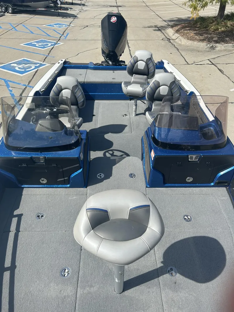 Slide: The Image of 2023 Nitro ZV20 fishing boat with seating and dual consoles in a parking lot. - 5