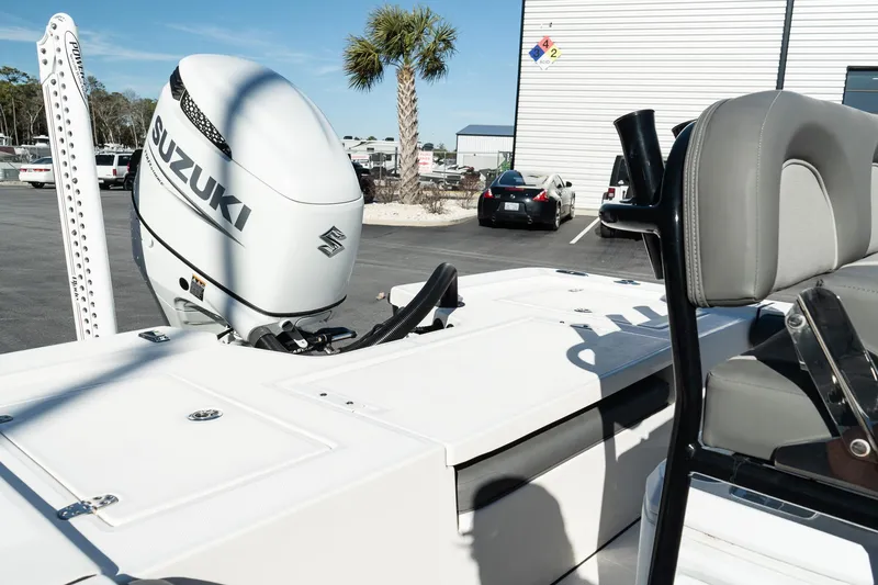 Slide: The Image of 2023 Sea Born FX22 Bay boat with Suzuki outboard motor in a marina setting. - 10