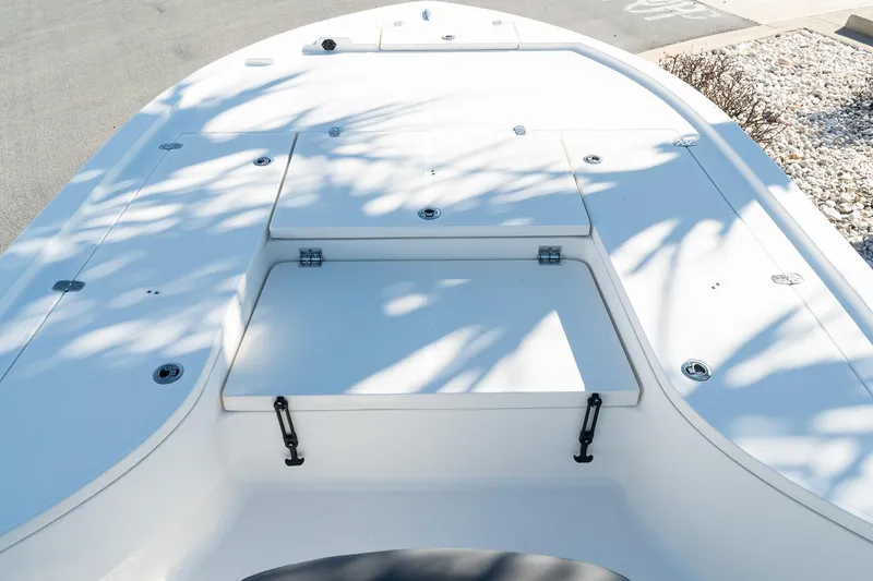 Slide: The Image of 2023 Sea Born FX22 Bay boat deck with storage compartments and shadow patterns. - 13