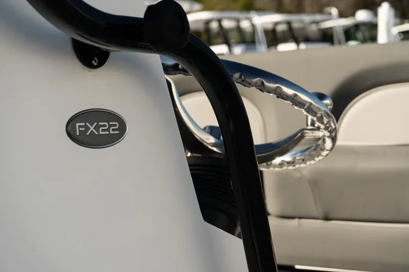 Slide: The Image of 2023 Sea Born FX22 Bay boat detail with steering wheel and model emblem. - 16