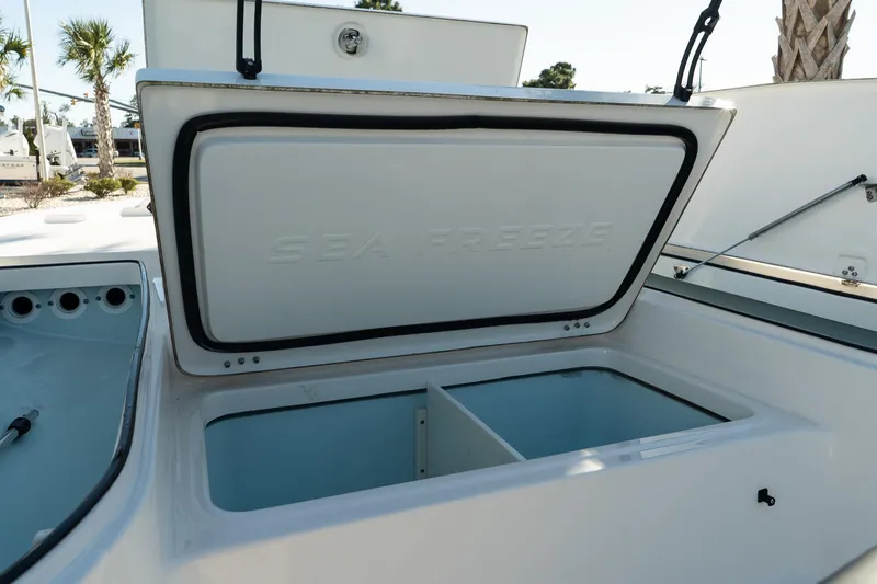 Slide: The Image of 2023 Sea Born FX22 Bay boat storage compartment open, showcasing interior space. - 17