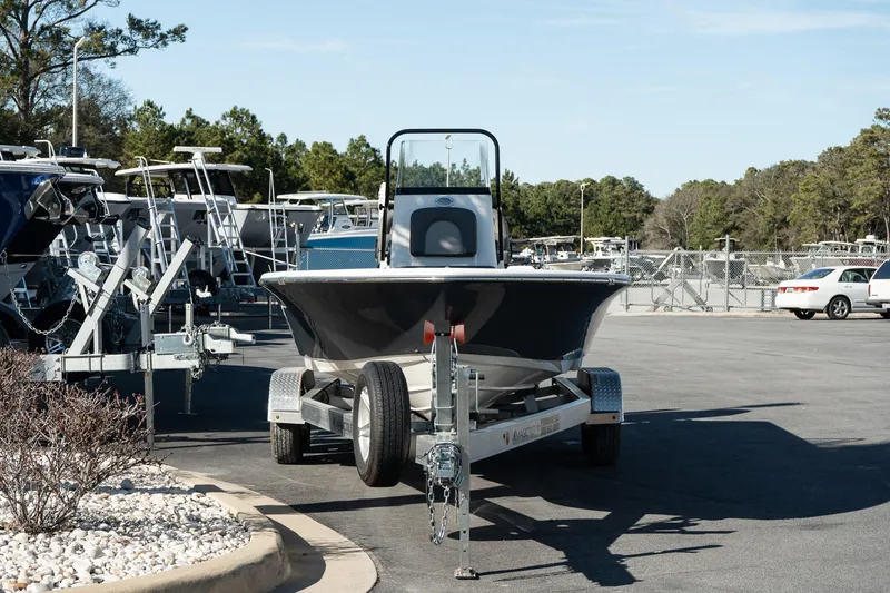 Slide: The Image of 2023 Sea Born FX22 Bay boat on trailer in parking lot. - 2
