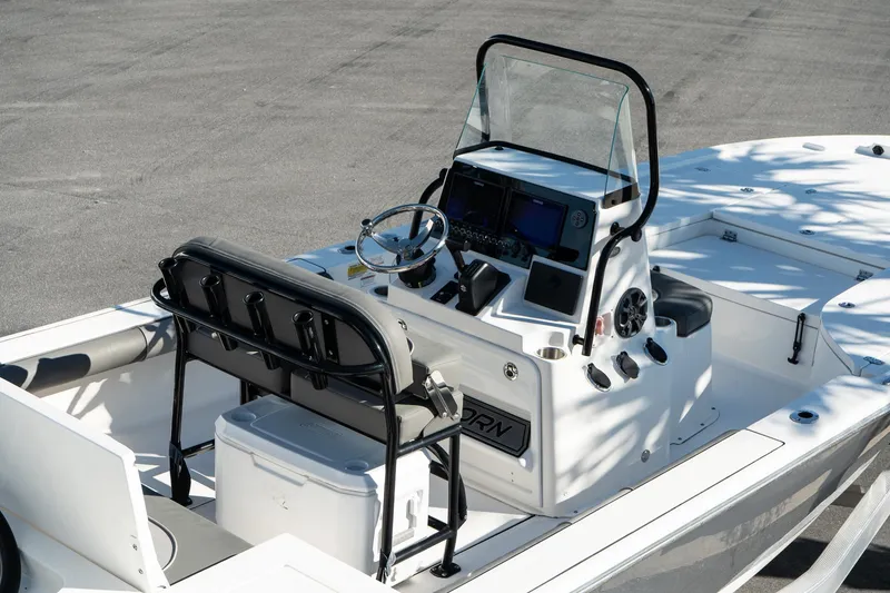 Slide: The Image of 2023 Sea Born FX22 Bay boat interior with steering console and seating. - 5