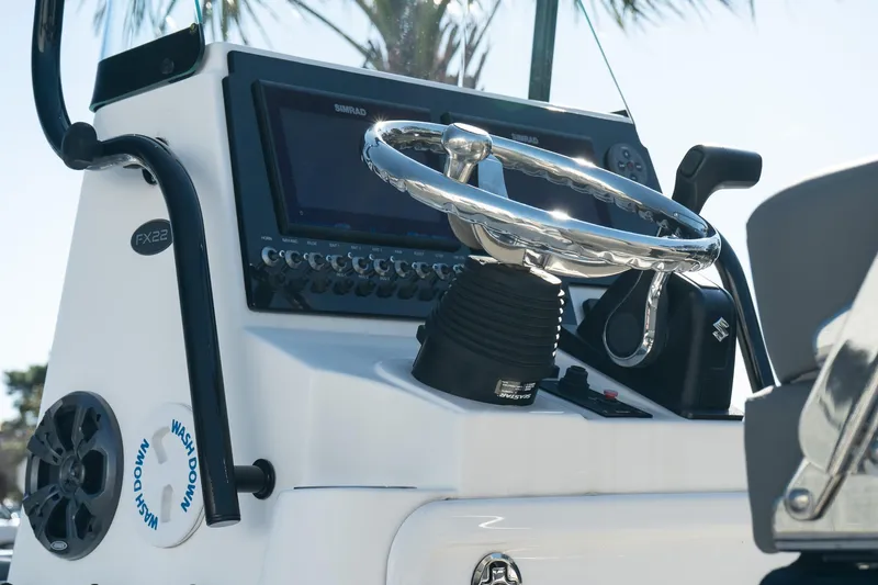 Slide: The Image of 2023 Sea Born FX22 Bay boat dashboard with steering wheel and controls. - 7