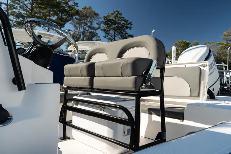 Slide: The Image of 2023 Sea Born FX22 Bay boat interior with cushioned seating and steering wheel. - 8