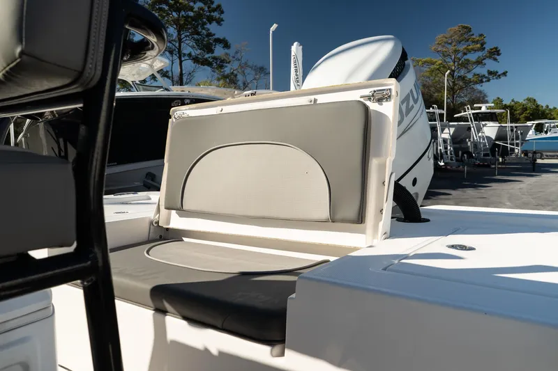 Slide: The Image of 2023 Sea Born FX22 Bay boat interior with seating and motor detail. - 9