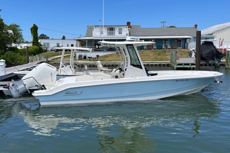 The Image of 2024 Boston Whaler 280 Dauntless boat docked in a marina, side view. - 0