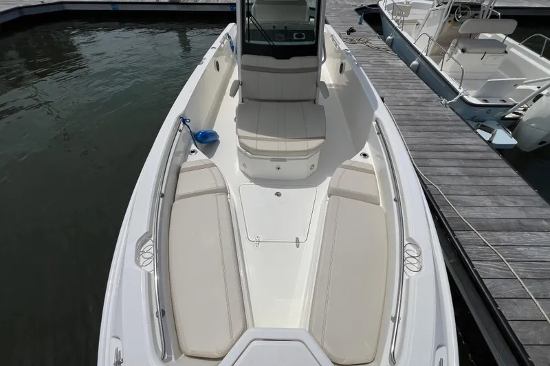 Slide: The Image of 2024 Boston Whaler 280 Dauntless boat docked, showcasing spacious seating and sleek design. - 1