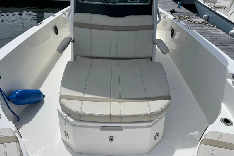 Slide: The Image of 2024 Boston Whaler 280 Dauntless boat interior with cushioned seating and armrests. - 10