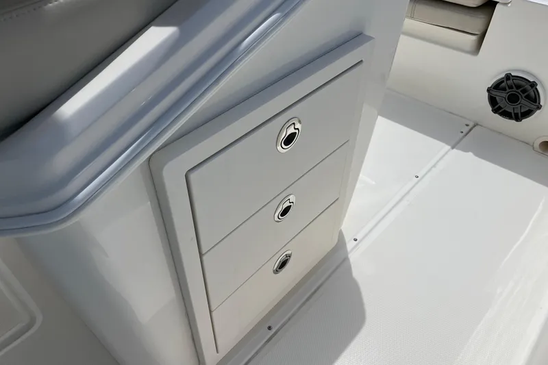 Slide: The Image of 2024 Boston Whaler 280 Dauntless interior storage drawers on deck. - 13