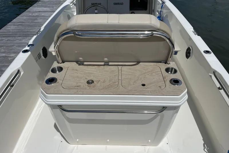 Slide: The Image of 2024 Boston Whaler 280 Dauntless boat interior with seating and cup holders. - 14