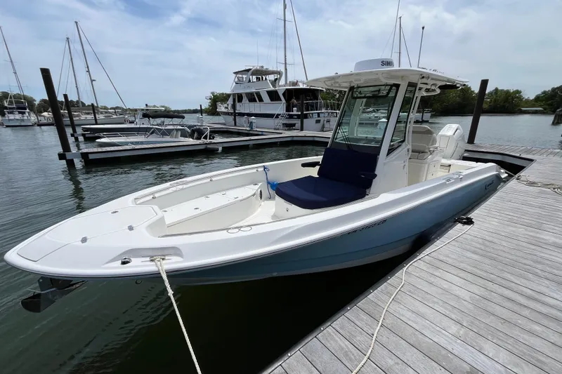 Slide: The Image of 2024 Boston Whaler 280 Dauntless boat docked at a marina, showcasing sleek design. - 17