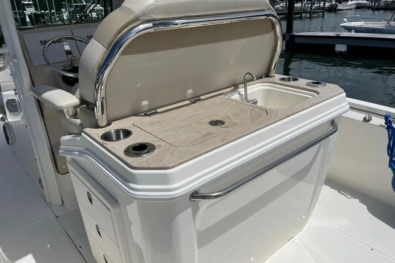 Slide: The Image of 2024 Boston Whaler 280 Dauntless boat interior with sink and storage compartments. - 3