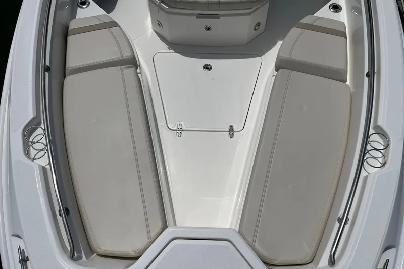 Slide: The Image of 2024 Boston Whaler 280 Dauntless boat interior with cushioned seating and storage. - 7