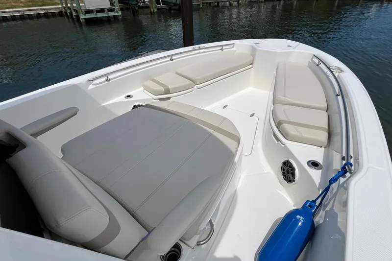 Slide: The Image of 2024 Boston Whaler 280 Dauntless boat interior with cushioned seating and blue fender. - 9