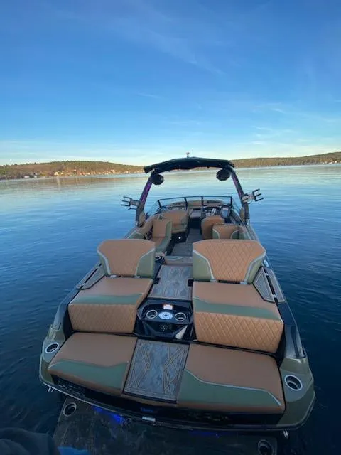 Slide: The Image of 2023 Tigé 24 RZX boat on calm water, featuring luxurious seating and sleek design. - 3