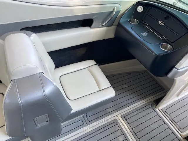 Slide: The Image of 2010 Sea Ray 230 Select boat interior with white and gray seating and dashboard. - 15