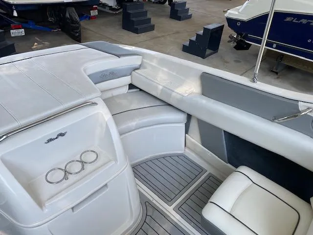 Slide: The Image of Interior of a 2010 Sea Ray 230 Select boat with white and gray seating. - 17