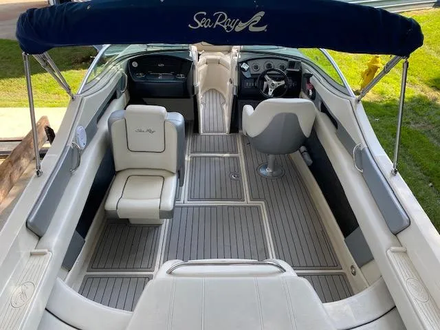 Slide: The Image of 2010 Sea Ray 230 Select boat interior with seating and steering wheel. - 23