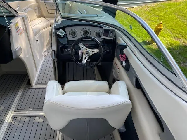 Slide: The Image of 2010 Sea Ray 230 Select boat interior with steering wheel and dashboard. - 7