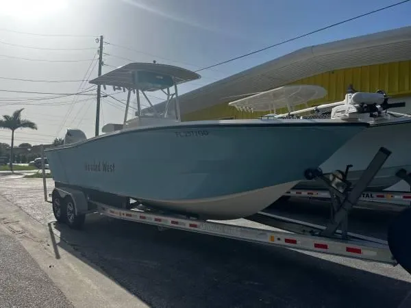 Slide: The Image of 1988 Hydra-Sports 2500 CC boat on a trailer in a parking lot. - 1